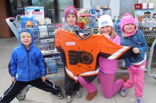 Young supporters of the Frontenac Minor Hockey Association, whose siblings play on the new novice rep team- l-r, Owen, Joshua, Julianna and Violet